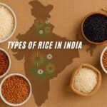 Assorted types of Indian rice displayed in bowls on a wooden table.
